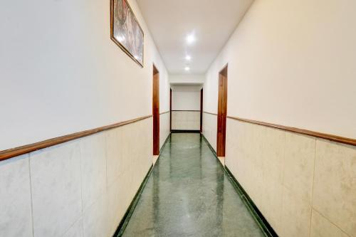 a corridor of an empty hallway with a glass floor at Super Townhouse Nagpur Airport Formerly Flora Inn in Dhantoli