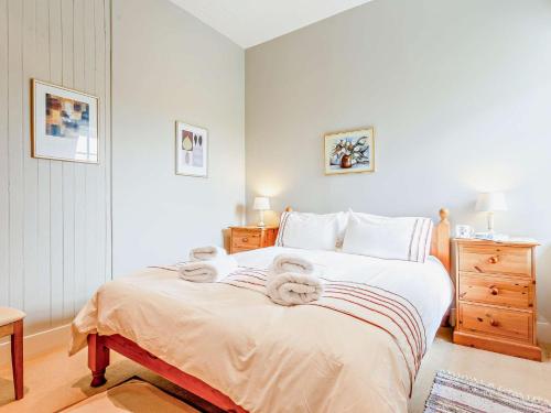 a bedroom with a bed with towels on it at 2 Bed in Conon Bridge CA387 in Cononbridge