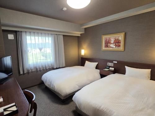 Ένα ή περισσότερα κρεβάτια σε δωμάτιο στο Hotel Route-Inn Odate Eki Minami