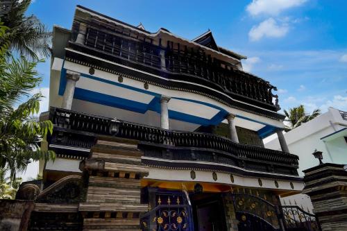 a tall building with blue and white trim at Hotel O Kazhakuttam Railway Station Formerly Graceful Stay in Trivandrum