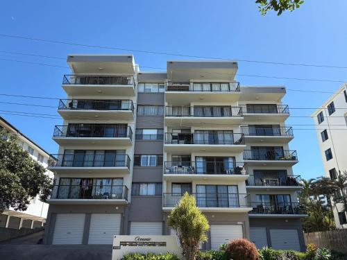 an apartment building with balconies and trees at Unit 13 Oceanic, Kings Beach in Caloundra