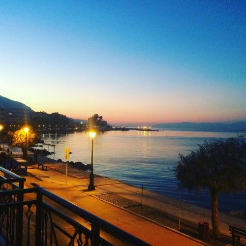 a view of a body of water at sunset at Hotel Kyani Akti in Xylokastron