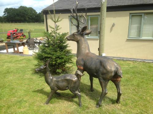 a statue of a mother deer and her baby at The Stables - Deer Park Farm in Solihull