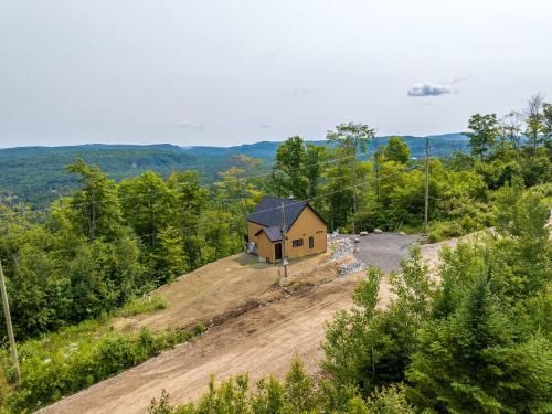 a small house on a hill in the woods at Absolute comfort with spa - Le Panorama in Saint Come