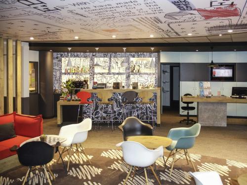 a lobby with chairs and tables and a bar at ibis Marseille Timone in Marseille