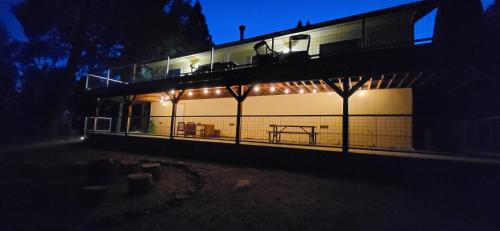 a building with lights on the side of it at night at Starlink Mariposa Yosemite mountain retreat in Mariposa