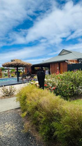 a house with a patio with a table and a umbrella at Bulabard Villa in Nayawa