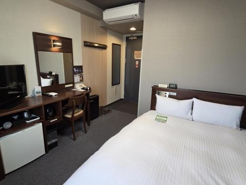 Ένα ή περισσότερα κρεβάτια σε δωμάτιο στο Hotel Route-Inn Odate Eki Minami