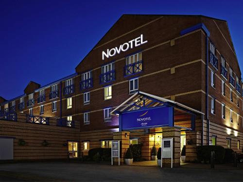 a novation hotel is lit up at night at Novotel Wolverhampton City Centre in Wolverhampton