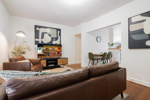 a living room with a couch and a table at StayCentral - Brunswick Vibe Parkville in Melbourne