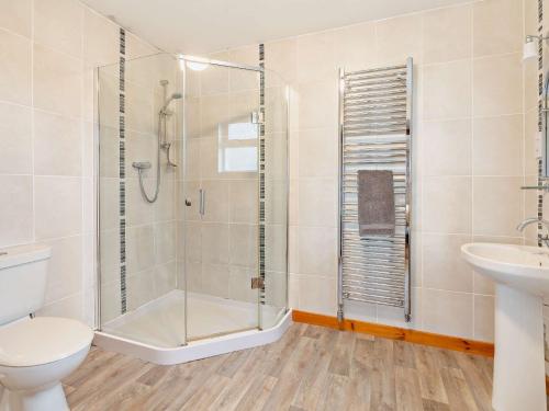 a bathroom with a shower and a toilet and a sink at 2 Bed in Edzell CA300 in Edzell