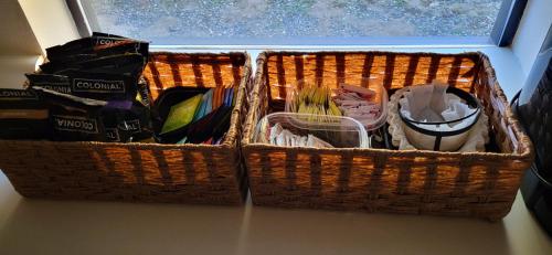 two baskets sitting on a table next to a window at Starlink Mariposa Yosemite mountain retreat in Mariposa