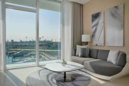 a living room with a couch and a table at W Abu Dhabi - Yas Island in Abu Dhabi