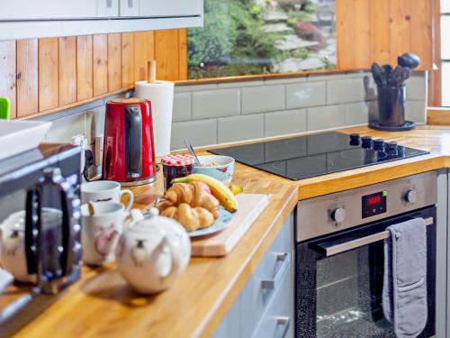 a kitchen counter with a plate of food on a counter top at 2 Bed in Withypool 77362 in Withypool
