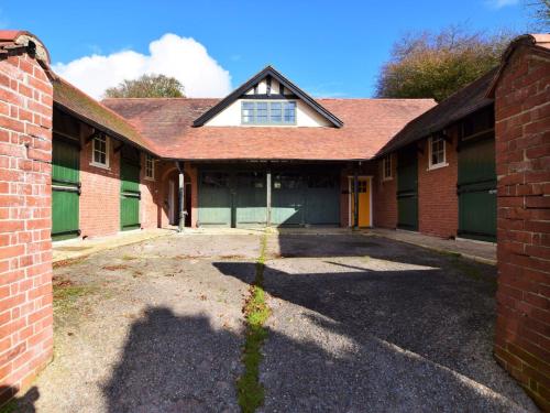 an old brick building with a window and a garage at 2 Bed in Withypool 77362 in Withypool