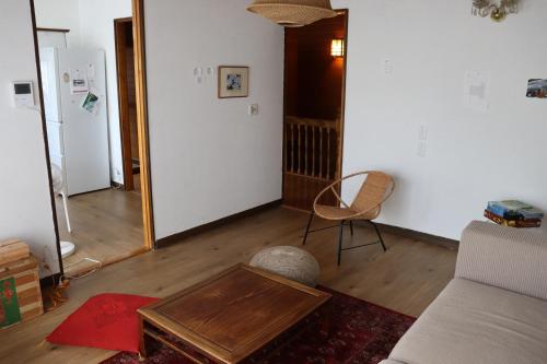 a living room with a couch and a table and a mirror at sharehouse&stay上海洋行 in Nagawa