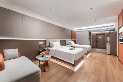 Ein Bett oder Betten in einem Zimmer der Unterkunft Huankai Hotel Pazhou Exhibition Center
