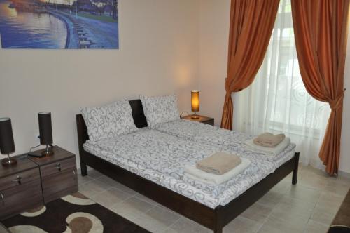 a bedroom with a bed with two pillows on it at Guest House Best Food in Subotica