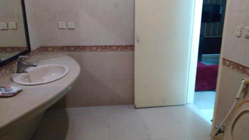 a bathroom with a sink and an open door at Premier Inn Heights hotel Davis Road Lahore in Lahore
