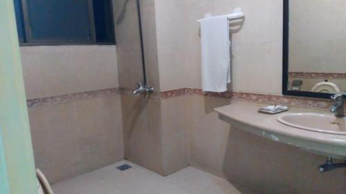 a bathroom with a sink and a shower at Premier Inn Heights hotel Davis Road Lahore in Lahore