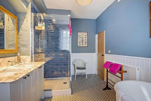 a bathroom with a shower and a sink at The East Wing in Wymondham