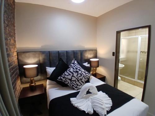 a bedroom with a bed with a towel on it at ATKV Klein-Kariba in Bela-Bela