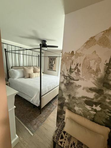 a bedroom with a bed and a painting on the wall at Townhouse in Prime Location! in McCall