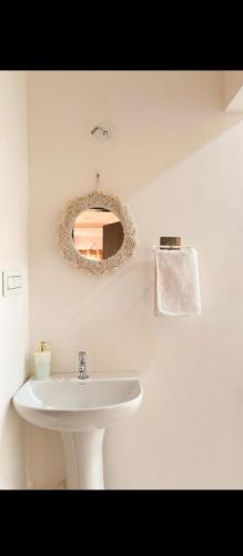 a bathroom with a sink and a mirror on the wall at Hotel nightout in Calangute