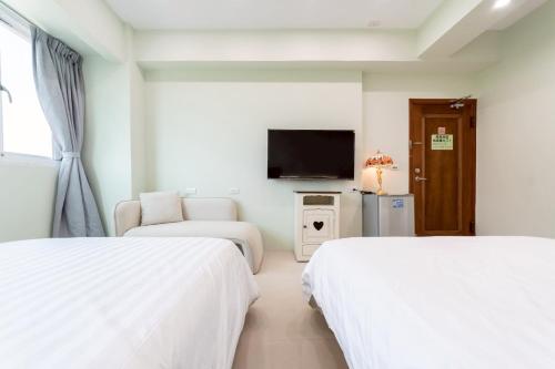 Postel nebo postele na pokoji v ubytování Bailuwar Anping B&B 預訂後務必連絡民宿再一次確認