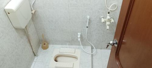 ein Badezimmer mit Toilette und Dusche in der Unterkunft London lodges Guest House in Karatschi