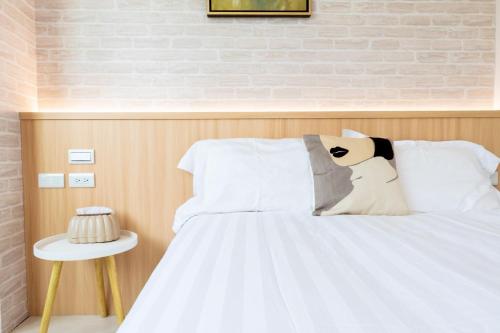 Postel nebo postele na pokoji v ubytování Bailuwar Anping B&B 預訂後務必連絡民宿再一次確認