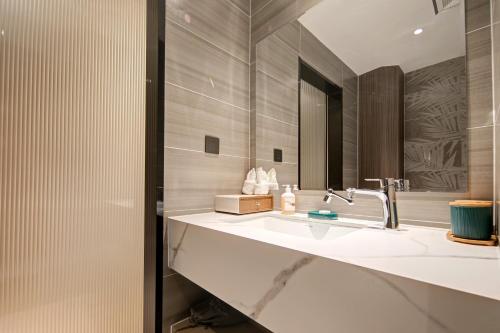a bathroom with a sink and a mirror at Floral Hotel Yunkexuan in Datong