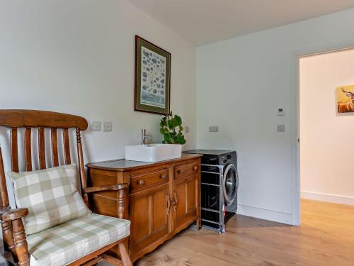 a bathroom with a sink and a washing machine at 5 Bed in Dulverton 87003 in Morebath