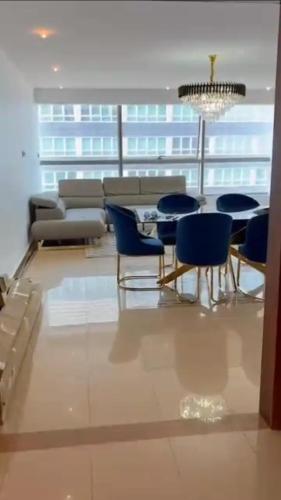 a living room with chairs and a table and a couch at Appartement mobilart haut standing in Oran