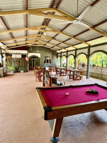 a pool table in a room with tables and chairs at Azomalli Hotel Boutique in Damían Carmona