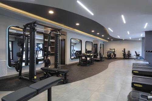 a gym with several treadmills and machines in a room at Clarion Hotel Real Tegucigalpa in Tegucigalpa