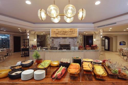 a restaurant with a table filled with different types of food at Clarion Hotel Real Tegucigalpa in Tegucigalpa