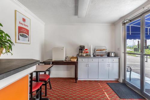 a kitchen with a counter and a table and a table at Econo Lodge Lee - Great Barrington in Lee
