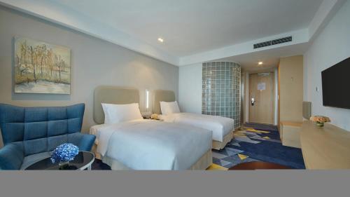 Ένα ή περισσότερα κρεβάτια σε δωμάτιο στο Holiday Inn Express - Qingdao West Coast by IHG
