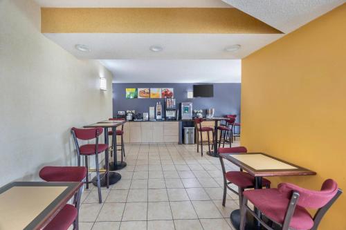 a restaurant with tables and chairs and a kitchen at Quality Inn Glasgow in Glasgow