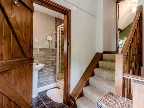 a bathroom with a staircase and a toilet and a sink at 1 Bed in Llangollen 78471 in Glyn-Ceiriog