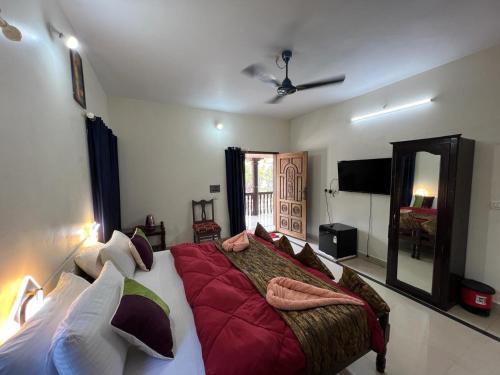 a bedroom with a large bed and a mirror at Sunshine beach resort in Varkala