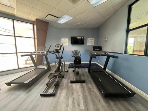 a gym with three tread machines in a room at Quality Inn Saint-Jean-sur-Richelieu in Saint-Jean-sur-Richelieu