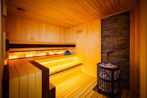 a sauna with a trash can in a wooden room at Kempinski Hotel Khan Palace in Ulaanbaatar