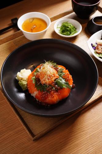 a black plate with a piece of food on a table at Hotel Indonesia Kempinski Jakarta in Jakarta