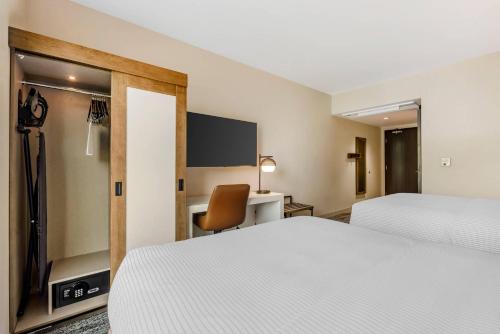 a hotel room with two beds and a desk at Cambria Hotel Portland - Pearl District in Portland