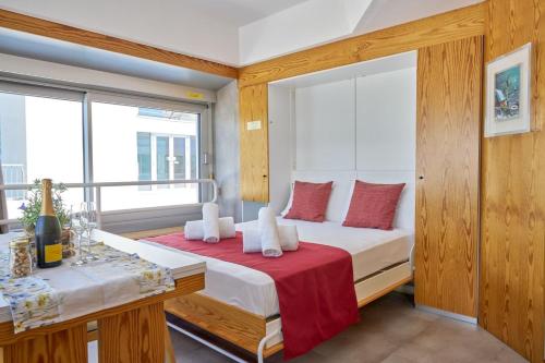 a bedroom with a bed and a window and a desk at Appartamento Samantha Residence Solaria Marilleva 1400 in Marilleva