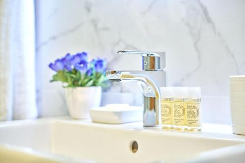 a bathroom sink with a faucet and a mirror at Appartamento Samantha Residence Solaria Marilleva 1400 in Marilleva