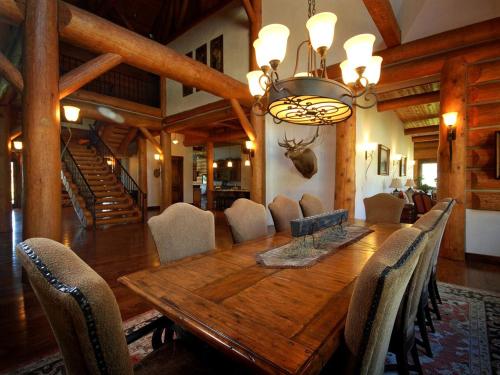 a dining room with a wooden table and chairs at Cozy Lodge Suite Rental with Mountain Views in Silver Bow County, Montana in Divide