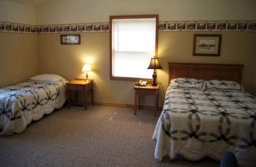 a bedroom with two beds and a window at Cozy Cabin Rental for a Camping Retreat on the Umpqua River in Oregon in Elkton
